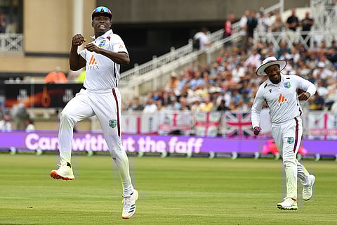 Kevin Sinclair celebrates Ollie Pope's wicket